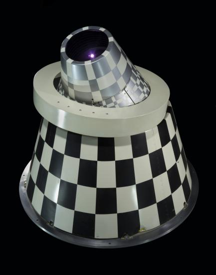 Rear view of an infrared sensor with black and white checkered cone with a ring mount.