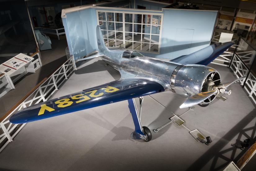 Top of metalic silver and blue Hughes H-1 Racer aircraft in museum