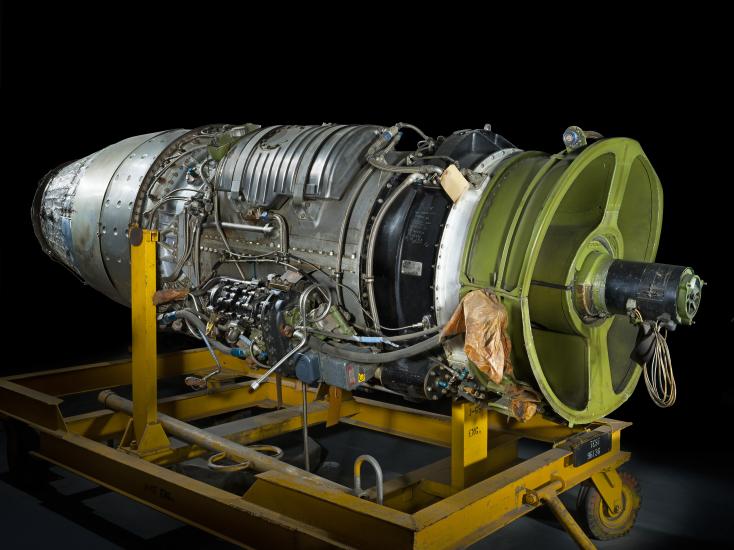 Bullet-shaped turbojet engine with green rear holding.