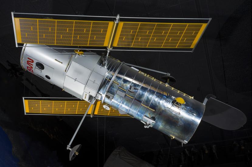 Side view of metal Hubble Space Telescope Model hanging in museum