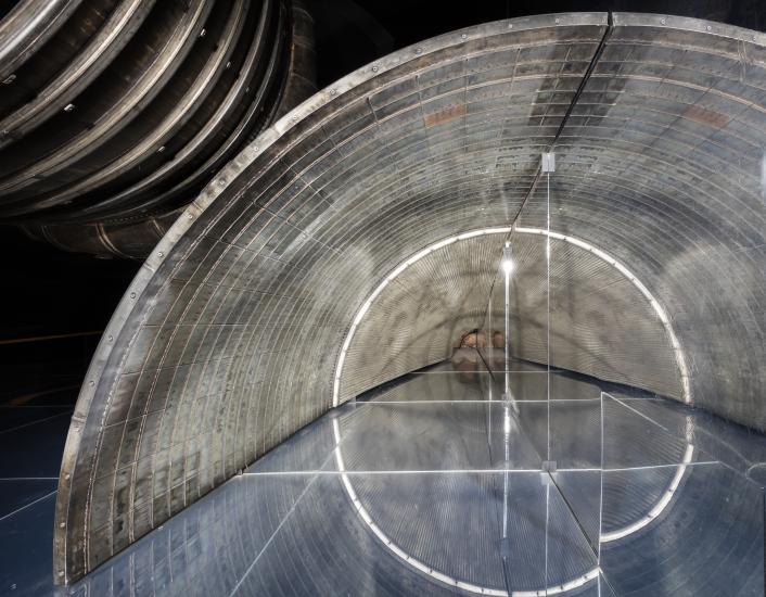 Rocket engine section set on a mirror to reveal internal contents.