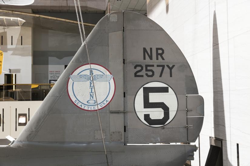 Boeing logo and "NR257Y" with "5" in white circle on vertical stabilizer on gray Boeing 247-D aircraft