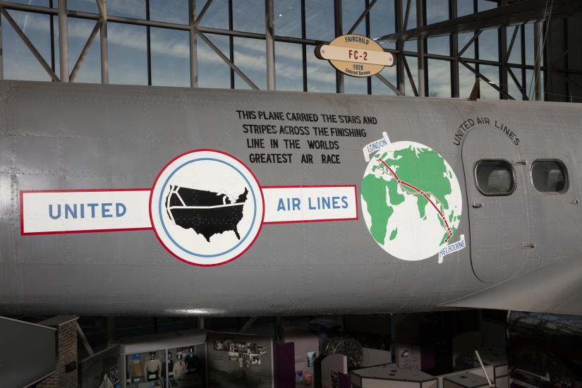 United States Airlines logo, globe, and record details on side of gray Boeing 247-D aircraft in museum