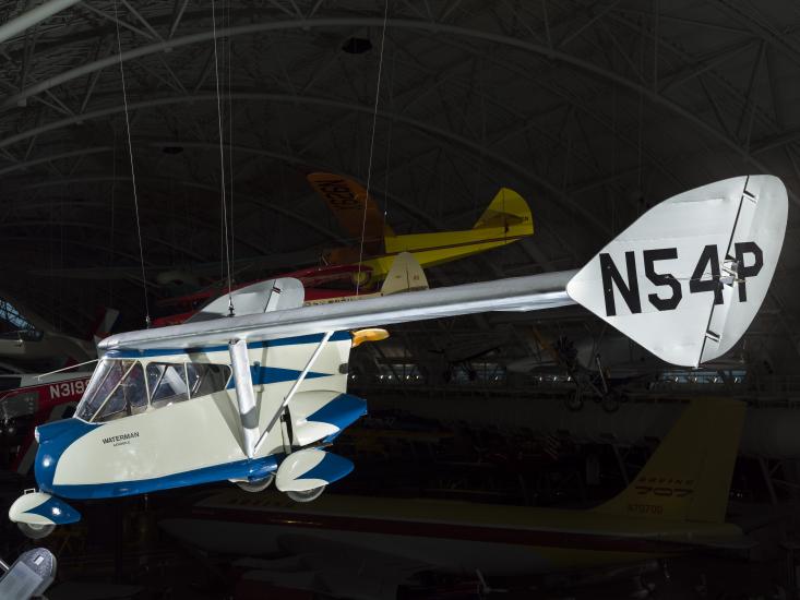 Painted blue and white roadable aircraft hanging in the museum. 