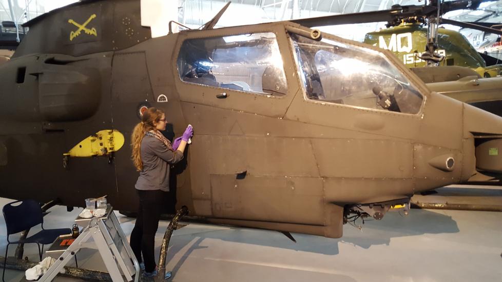 Conservator cleans the surface of a helicopter.