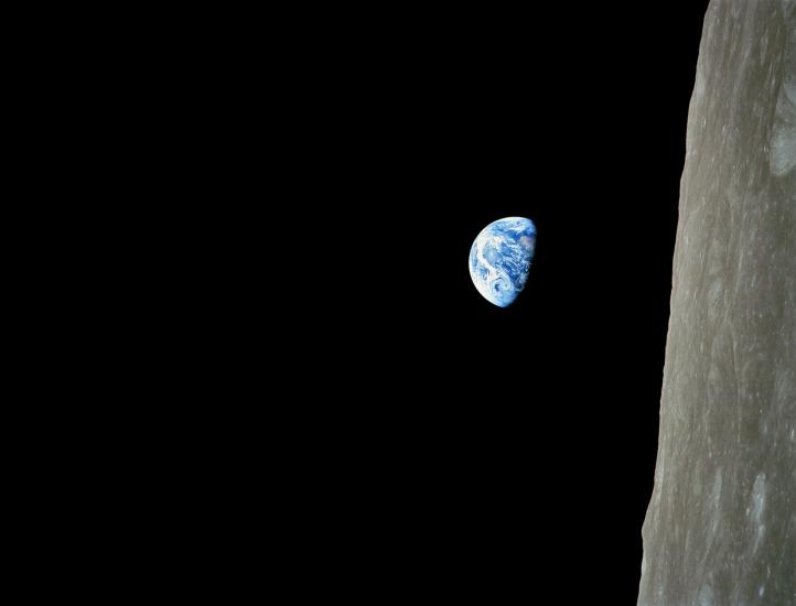 The Earth rises from the perspective of orbiting the Moon.