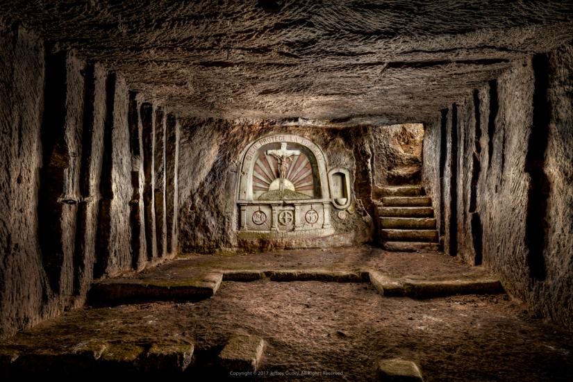 An underground chapel space carved during World War I. A set of stairs on the right of the altar allows for easy access to the trenches.