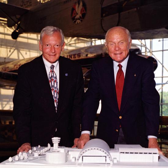 Senator John Glenn (right) and General J.R. Dailey (left) stand together with a model of the soon-to-be-built Steven F. Udvar-Hazy Center.