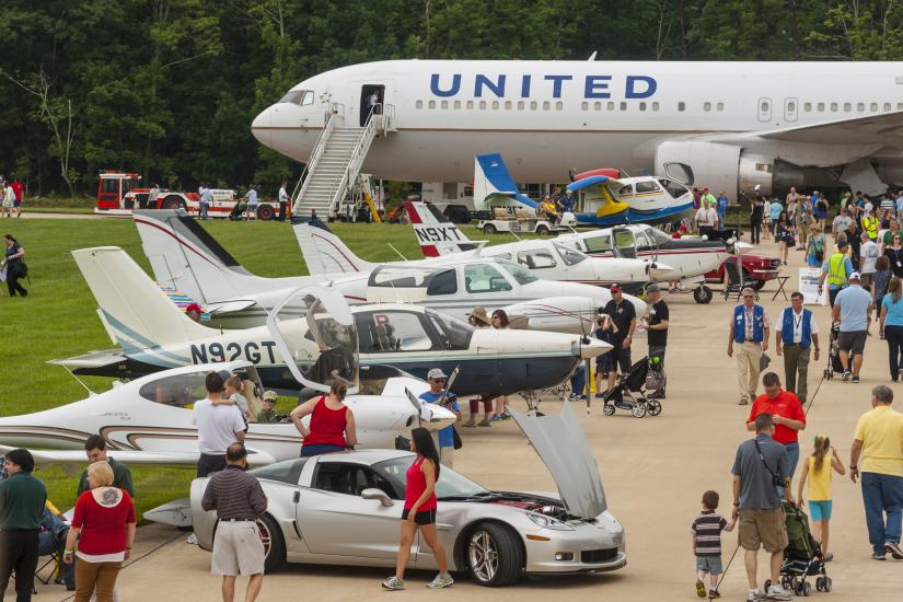 View of the runway at a airplane and car show. 