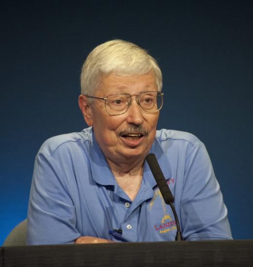 Peter Theisinger, a older white male, speaks as part of a panel.