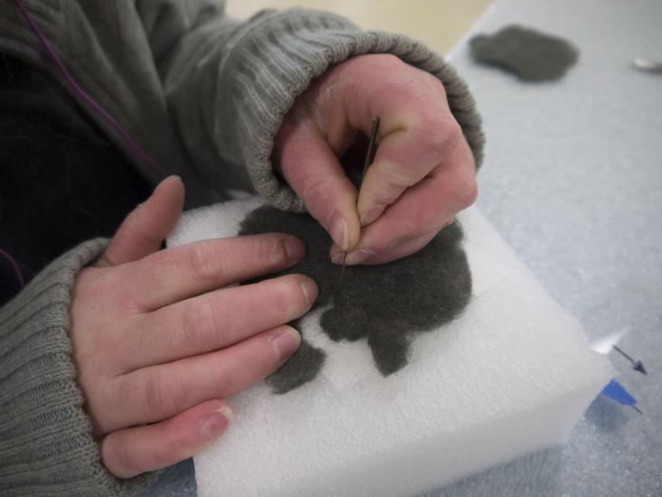 Close-up of hands needle-felting