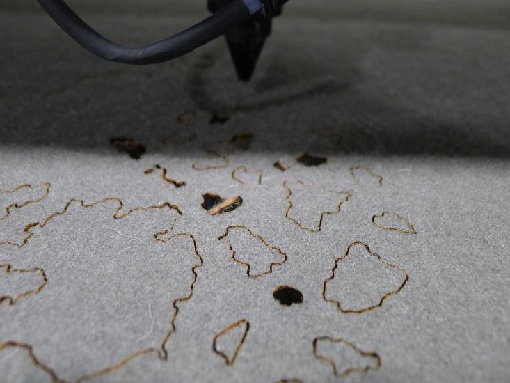 close-up view of fabric being cut with laser cutting