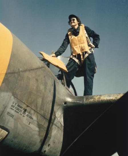 WASP climbing into a Lockheed P-38 preparatory to ferrying mission