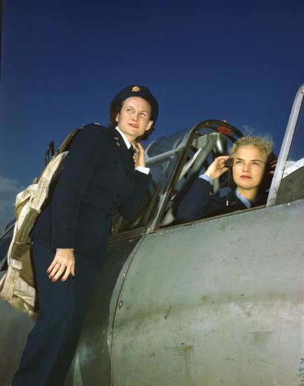 WASP Ann McClellan adjusts her earphones in the cockpit of a BT-13