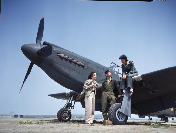 “WAFs and Army Pilot. The girls pilot the P-51s and other airplanes from factory to airbases within the United States.”