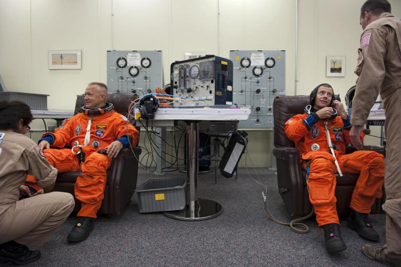 astronauts in orange flight suits