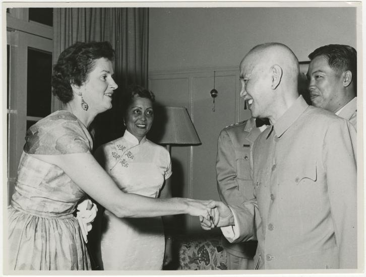 Agatha Davis watches Chiang Kai-Shek shake a woman's hand