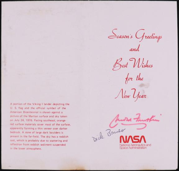 Left side, preprinted caption in red. Right side: preprinted message in red cursive font Season’s Greetings and Best Wishes for the New Year. Arnold Frutkin signature in red, Dick Barnes signature in black. NASA logo in red.