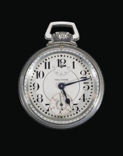 Silver torpedo boat watch with black hands at 5:12. Inset dial on watch at the 12 reads "DN 24 18 12 6 0 UP" Dial on watch at the 6 with markings 10 20 30 40 (hidden) 50 60