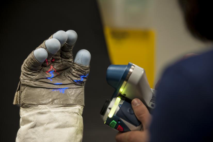 Close up of glove with laser lights projected on palm.