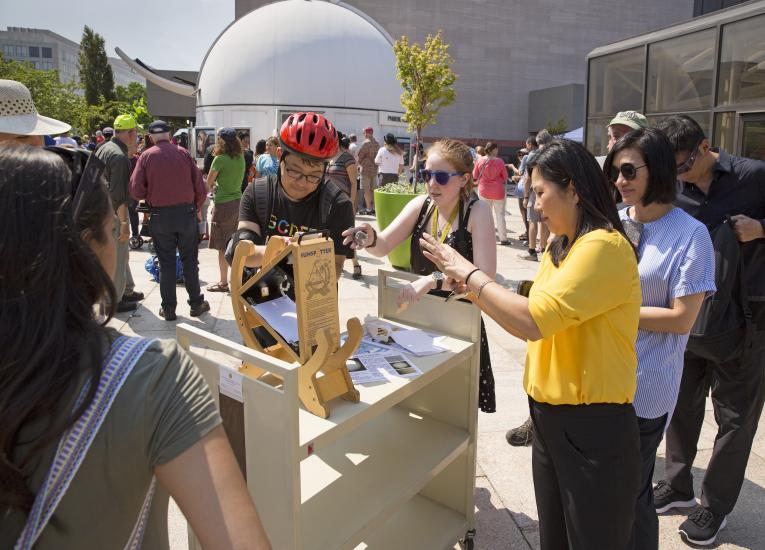 Visitors use a Sunspotter telescope