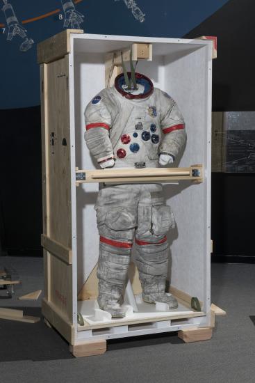 Gene Cernan's Apollo 17 spacesuit being moved out of the exhibit case in the "Apollo to Moon" gallery 