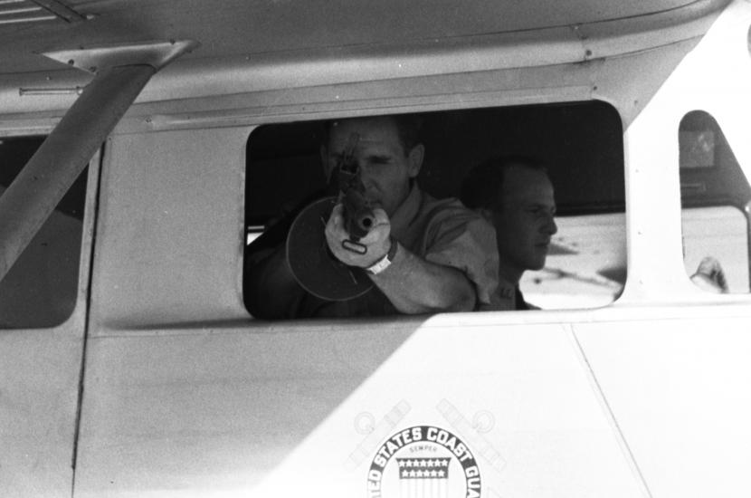 A photo of a Coast Guardsman during a demonstration on handling drug smuggling.