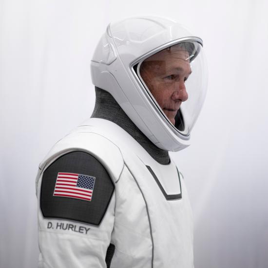 profile view of Doug Hurley in spacesuit