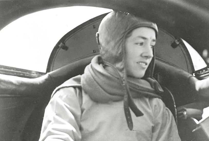 Anne Lindbergh, a white woman, sits aboard an aircraft.