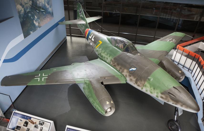 Top view of a green and gray camouflage fighter military monoplane with two engines. Monoplane is on display in the Museum.