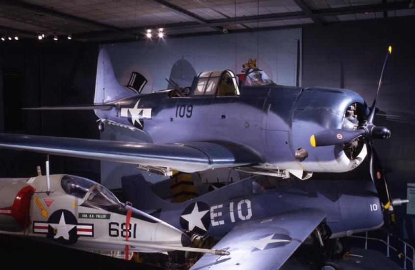 A blue grey airplane with a propeller. 