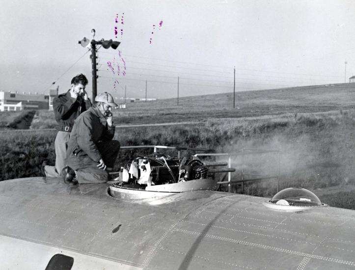 Two men on top of aircraft