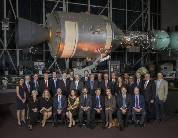 Two rows of people in suits seated for portrait