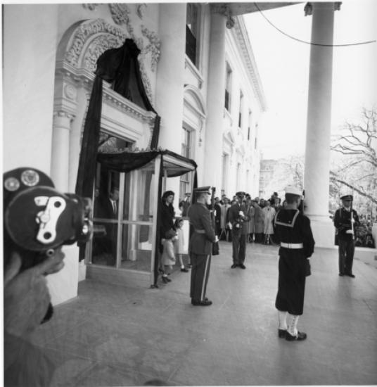 Jacqueline Kennedy, holding the hands of her children John and Caroline, exits the White House on the day of President John F. Kennedy's funeral. 