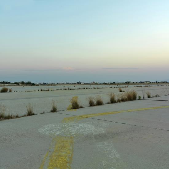 Grass grows through the cracks of the ruwnay at the Ellinikon International Airport runway in Athens, Greece, which closed in 2001. This photo of the now-defunct airport was taken in 2007. 