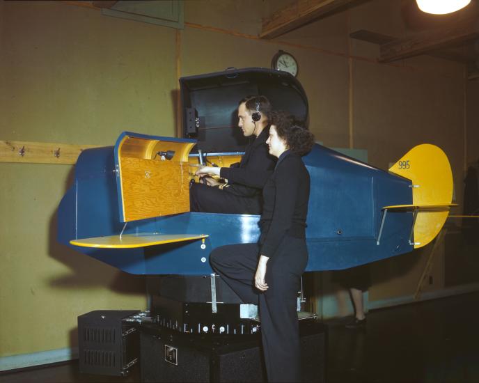 A WAVES Link Trainer instructor gives pointers to an officer