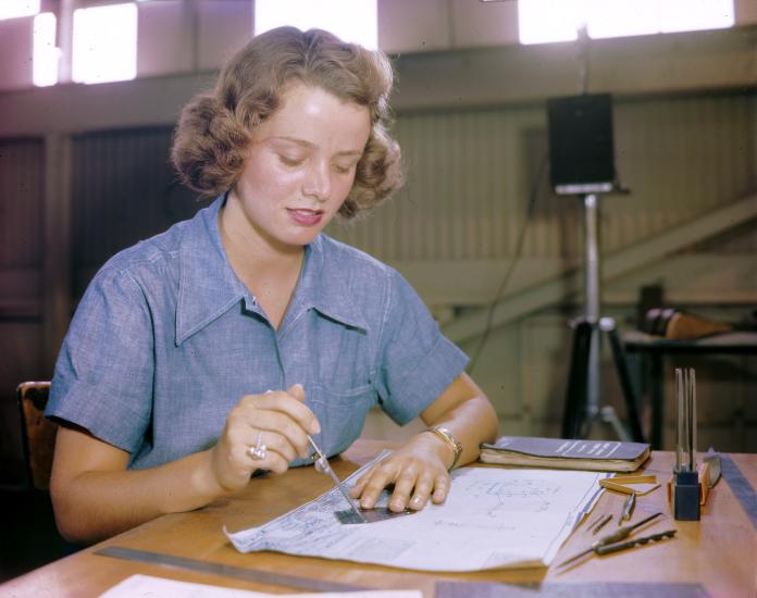 Elizabeth Holbrook and many other WAVES work in a huge assembly and repair building at a Naval Air Station in Hawaii