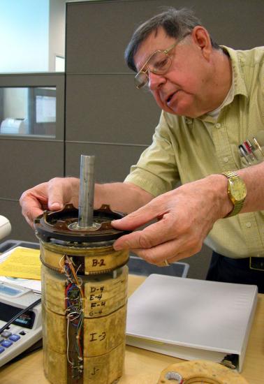 George Ludwig fitting his cosmic-ray detector with the Museum's Explorer 1 satellite.