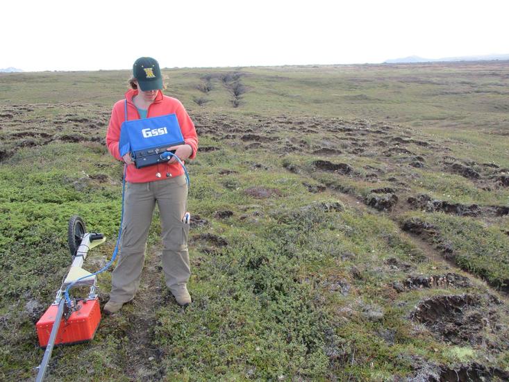 The author using a ground penetrating radar system to image the location of the soil-bedrock boundary. 