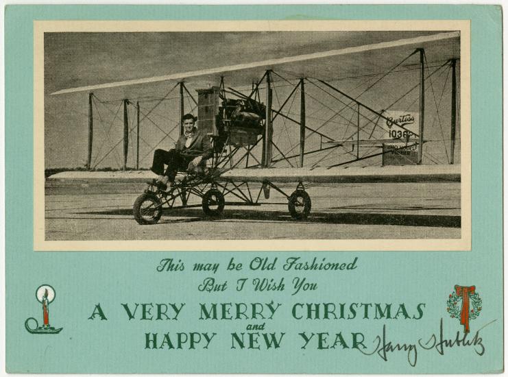 Christmas Card with photo of a man flying a Curtiss aircraft