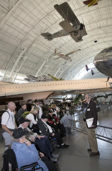 A group of veterans touring the Steven F. Udvar-Hazy Center in Chantilly, VA with a docent.