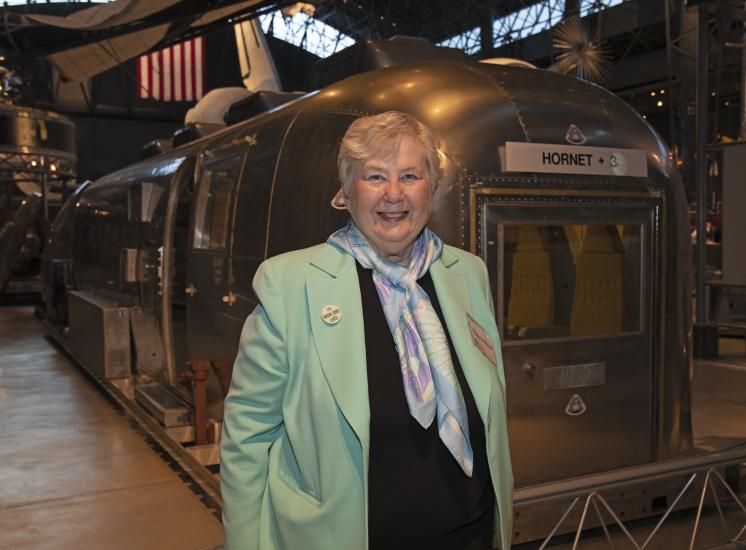 Woman stands in front of mobile quarantine facility