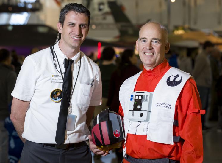 Man wearing Apollo 11 mission control costume and man wearing Star Wars costume