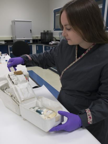 Engen Pre-program Conservation Fellow Meghann Kozak examines the Apollo 11 medical accessory kit in the Museum’s Emil Buehler Conservation Laboratory. 