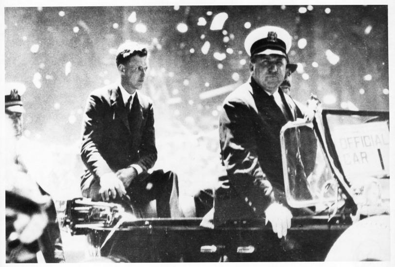 Informal portrait of Charles Lindbergh in a parade. 