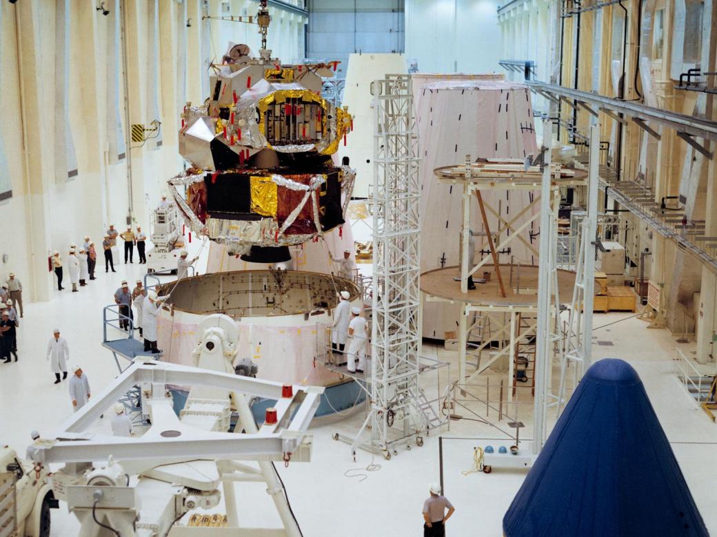 A color photograph of Lunar Module 1 being moved into position for mating with Spacecraft Lunar Module Adapter 7 in the Kennedy Space Center's Manned Spacecraft Operations Building.