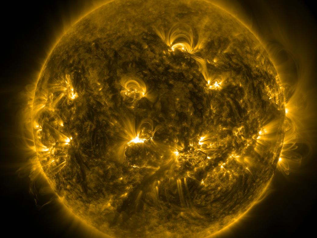 A picture of the sun with brilliant yellow flares coming off its globe-like shape.