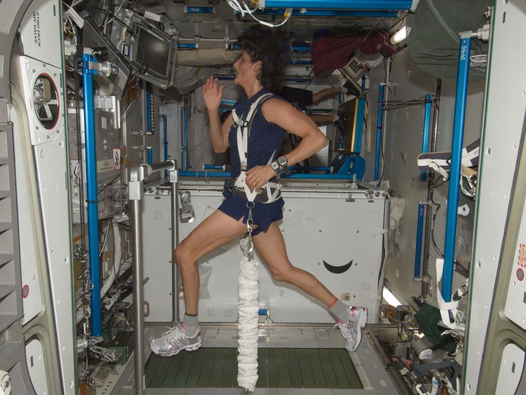 NASA astronaut Sunita Williams exercising on a treadmill aboard the International Space Station, 2012.