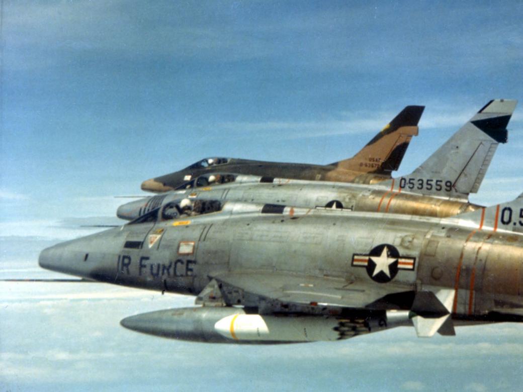 F-100Ds of the 481st Tactical Fighter Squadron over South Vietnam in February 1966. Early, unpainted F-100s are in the forerground. Camouflage painted aircraft in the back.