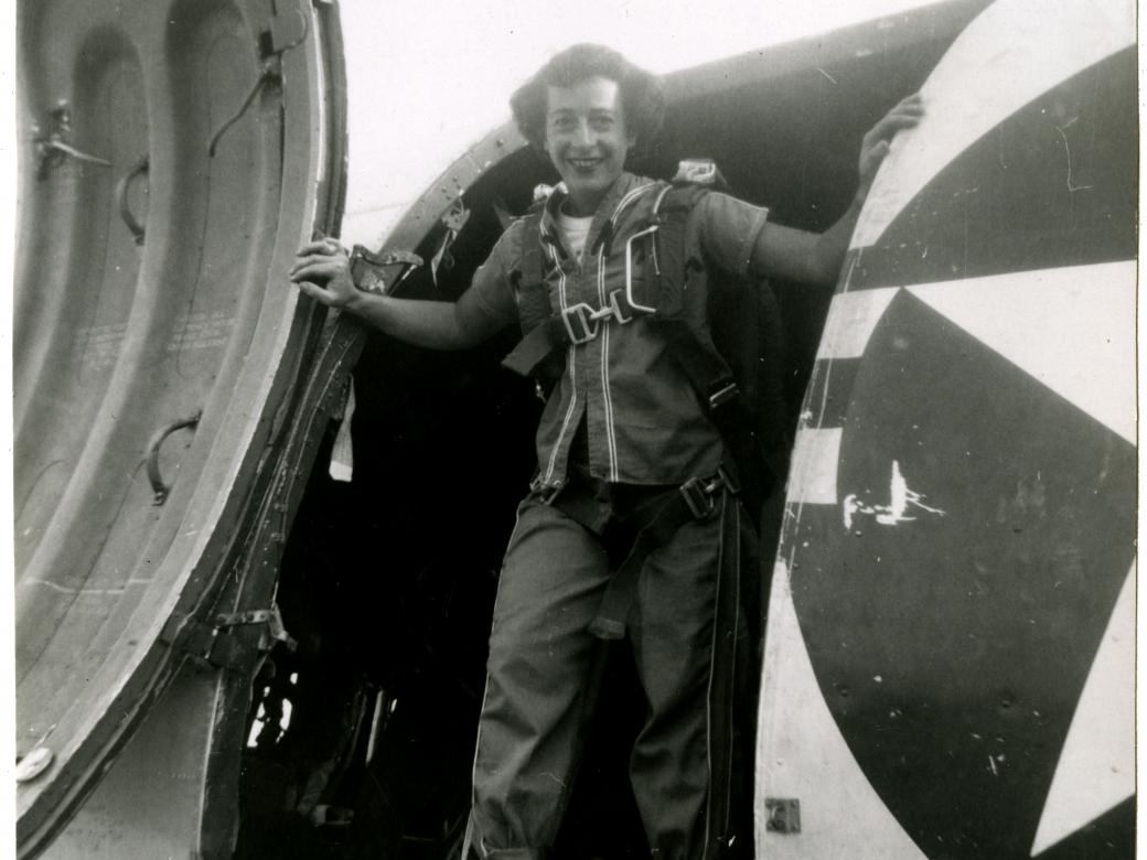 View of Helen G. James posed inside the main cargo door of a Douglas C-47 Skytrain. 